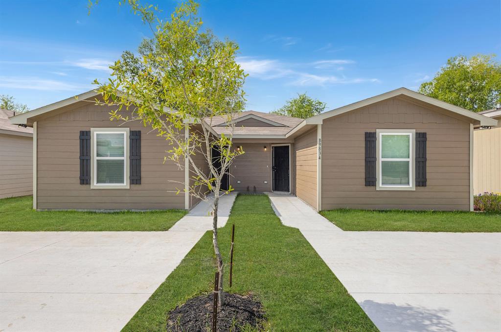 a front view of a house with a yard