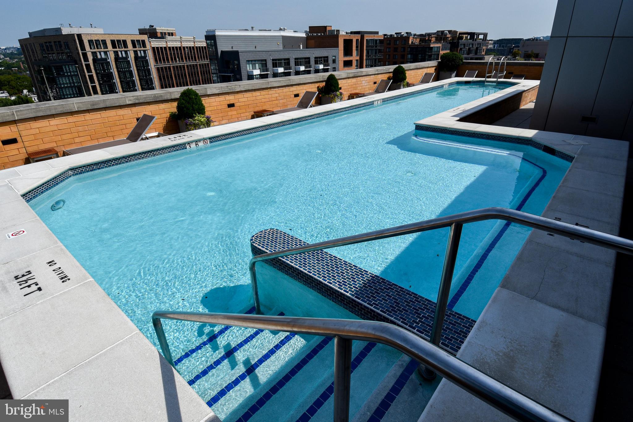 a view of swimming pool with furniture