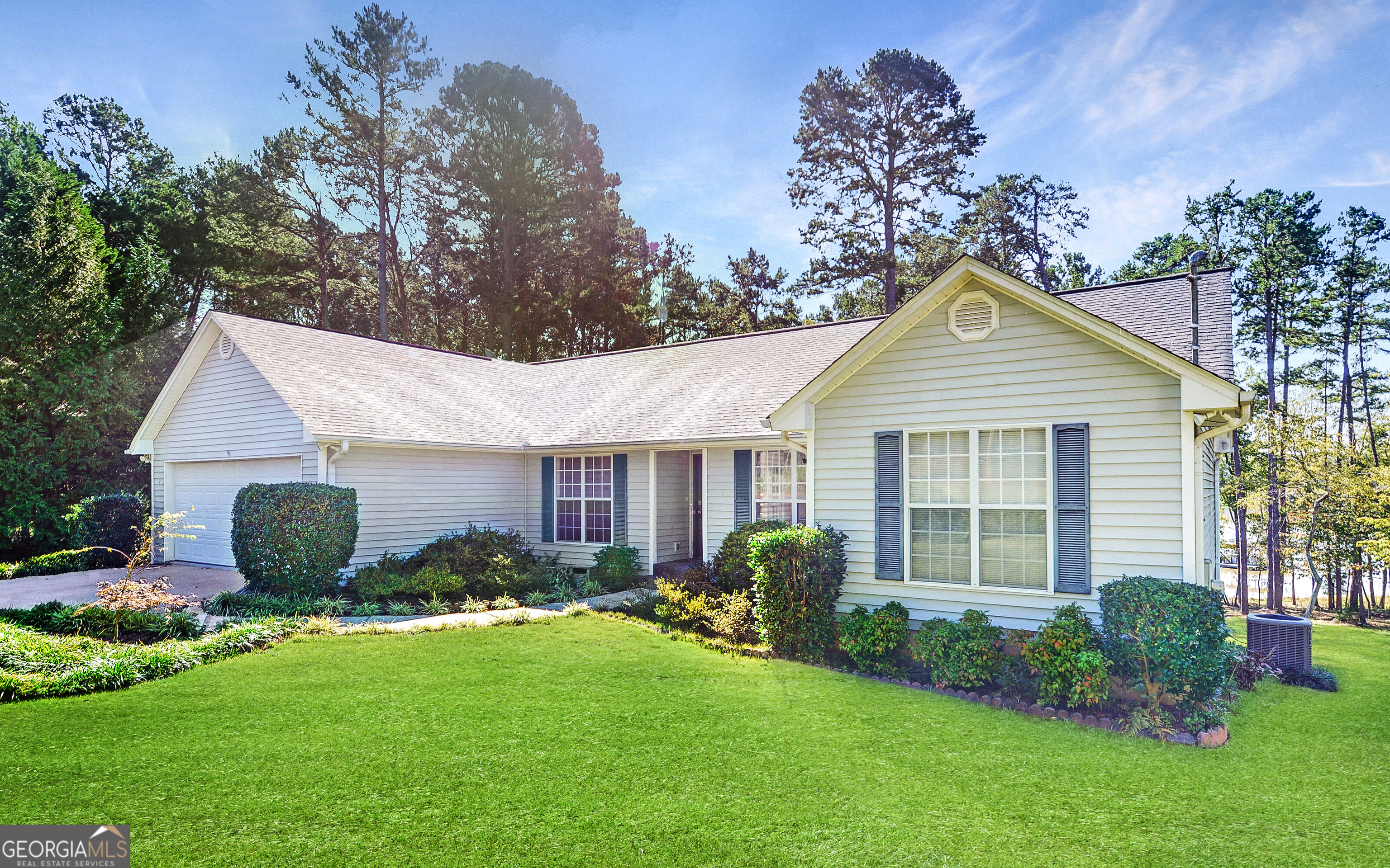 a front view of house with yard and green space