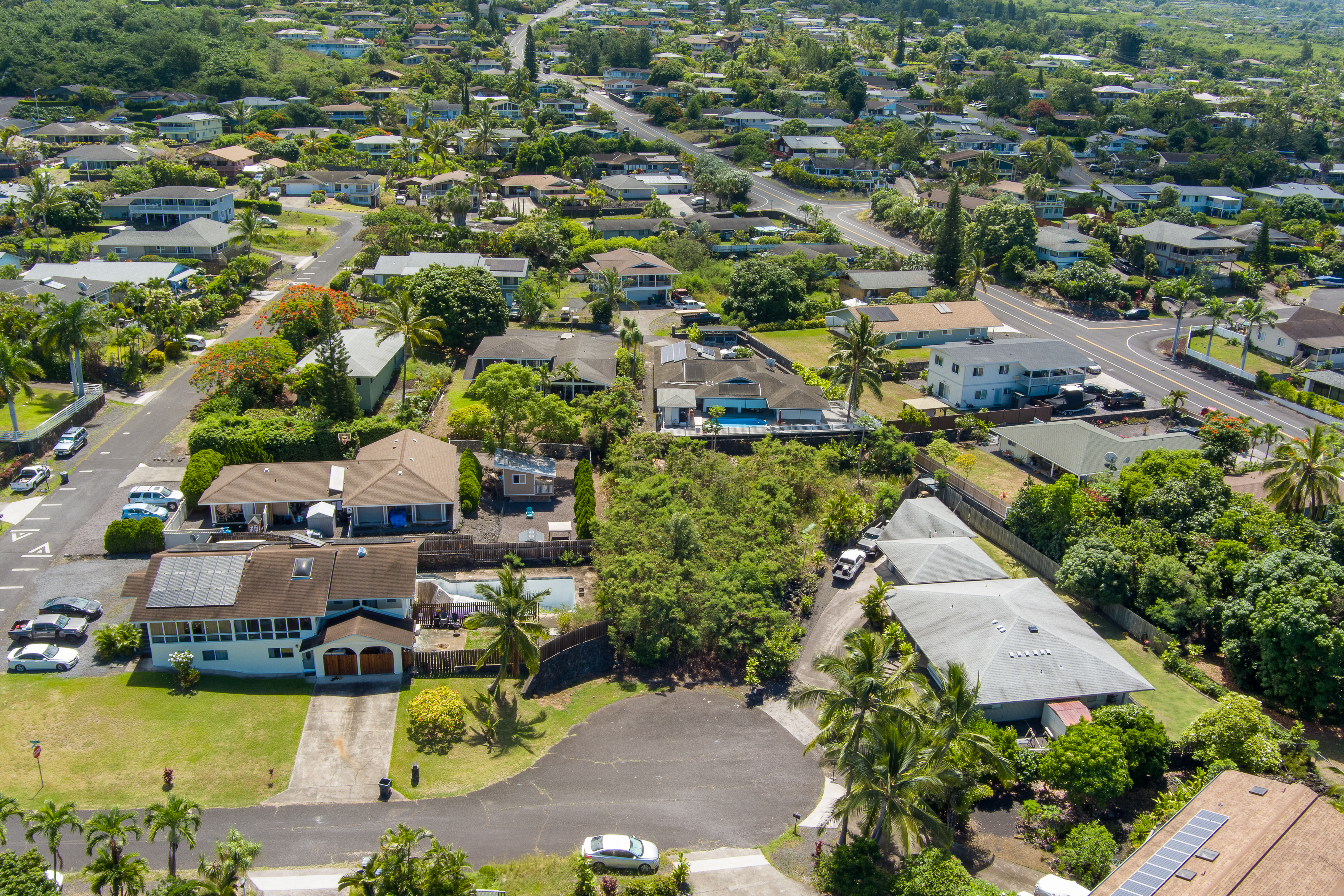 an aerial view of a house with a garden and lake view