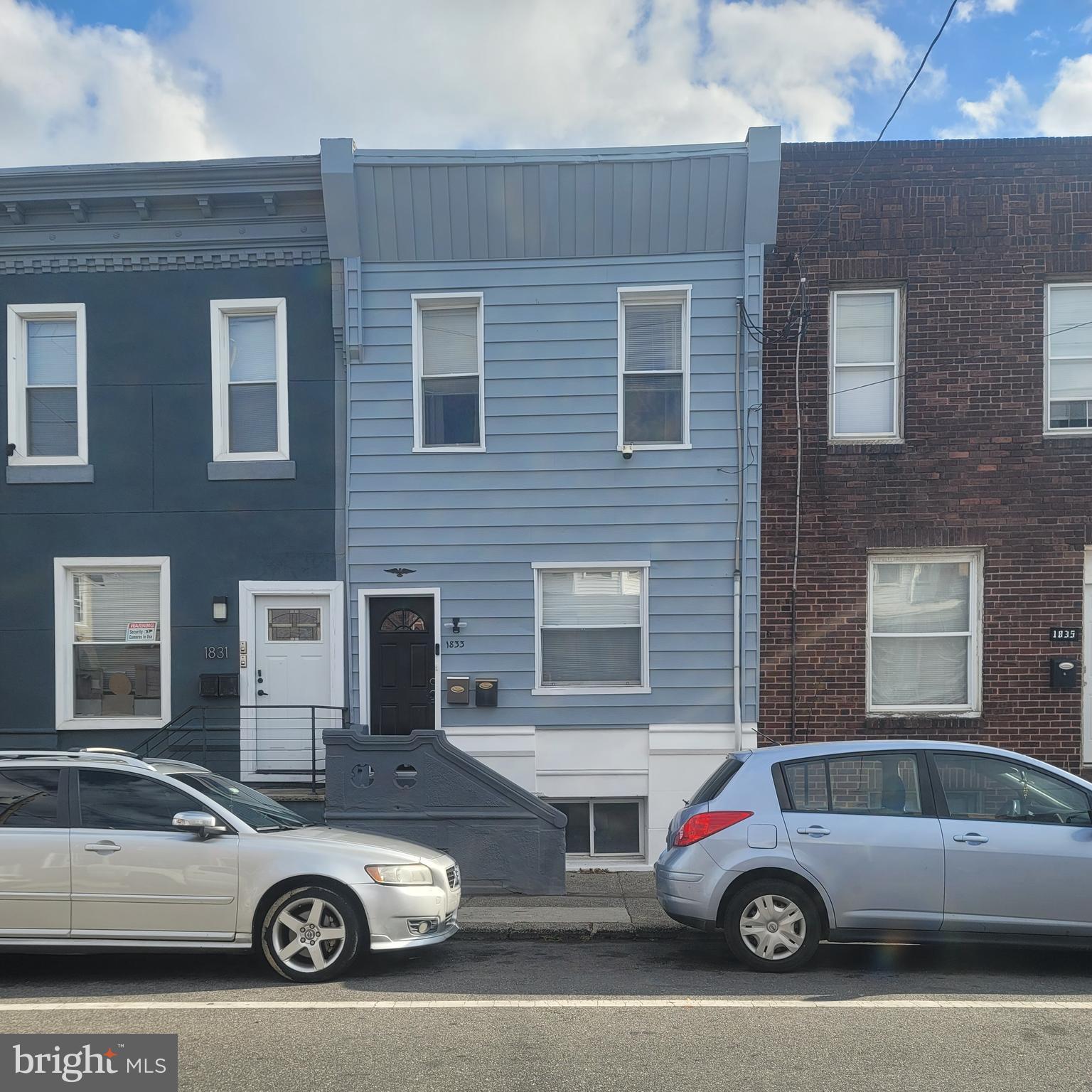 a car parked in front of a brick house