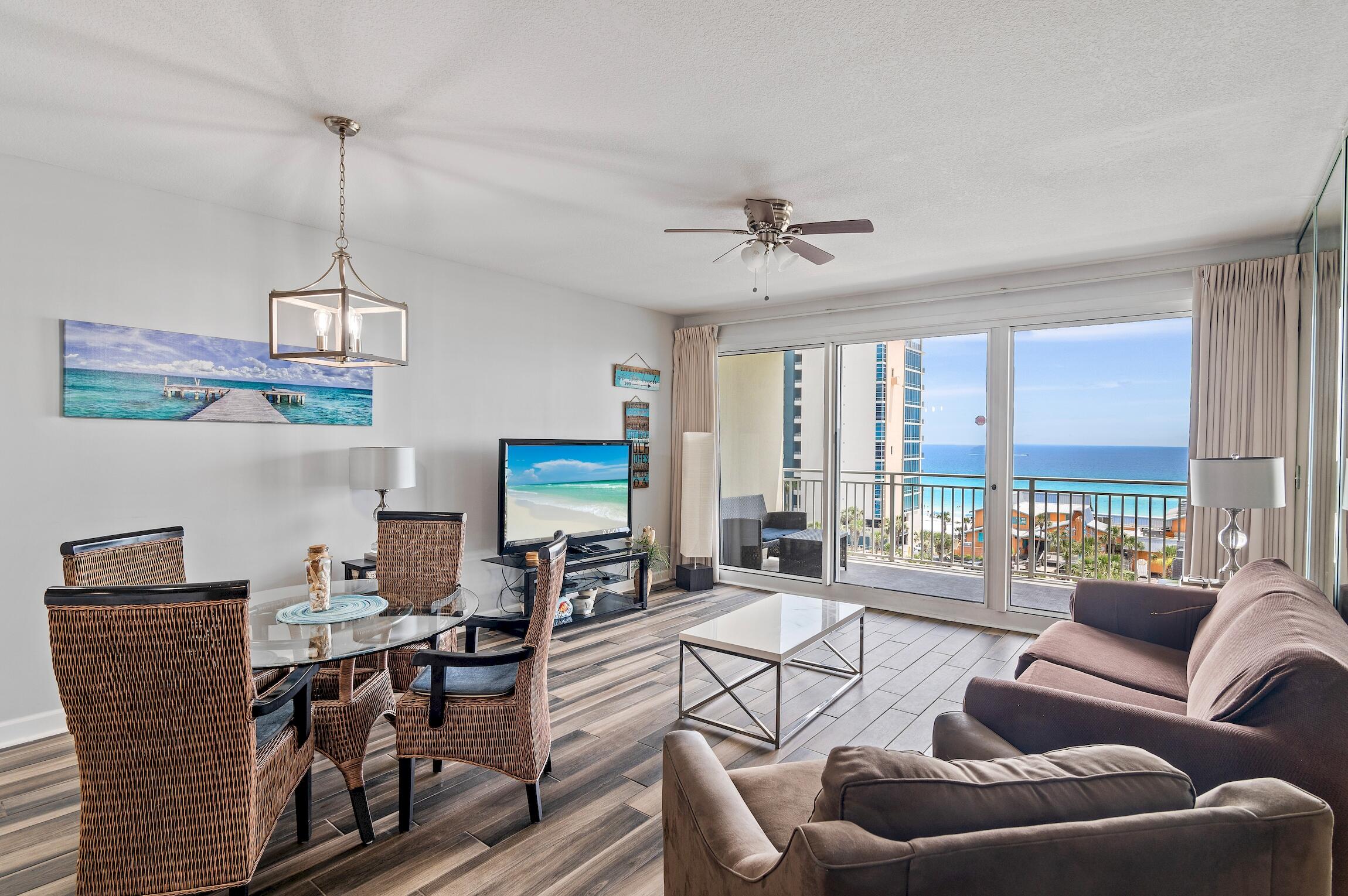 a living room with furniture a flat screen tv and a large window