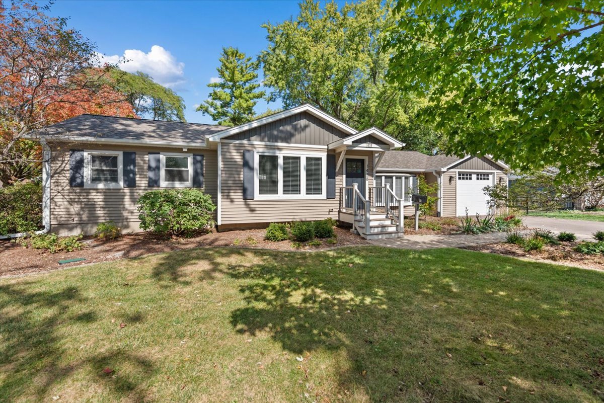 a front view of a house with yard and green space