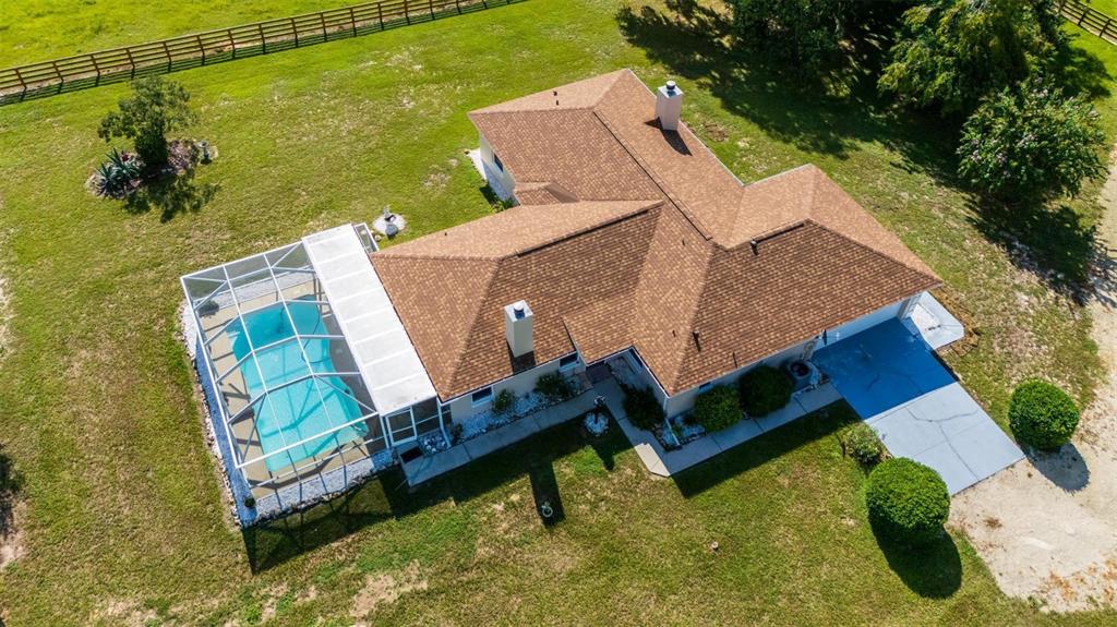 an aerial view of a house with outdoor space