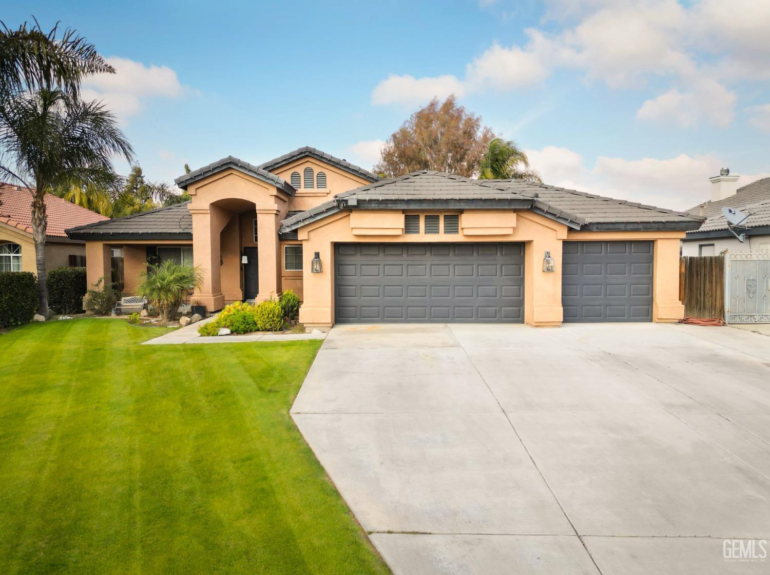 a front view of a house with yard and green space