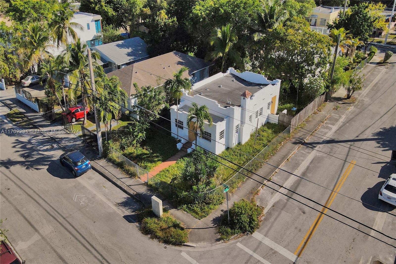 a view of a house with a yard and potted plants