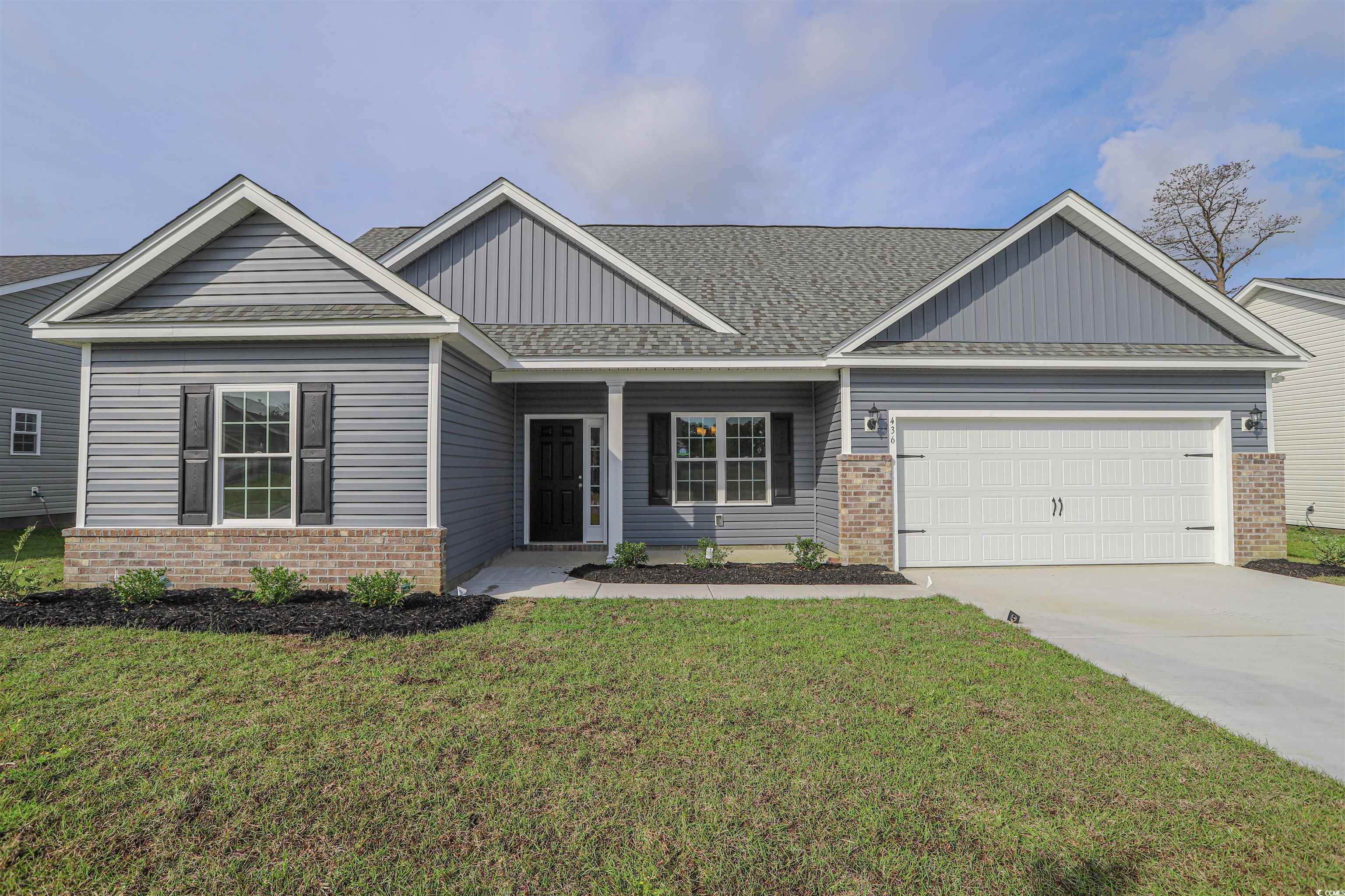 Craftsman house with a front lawn and a garage