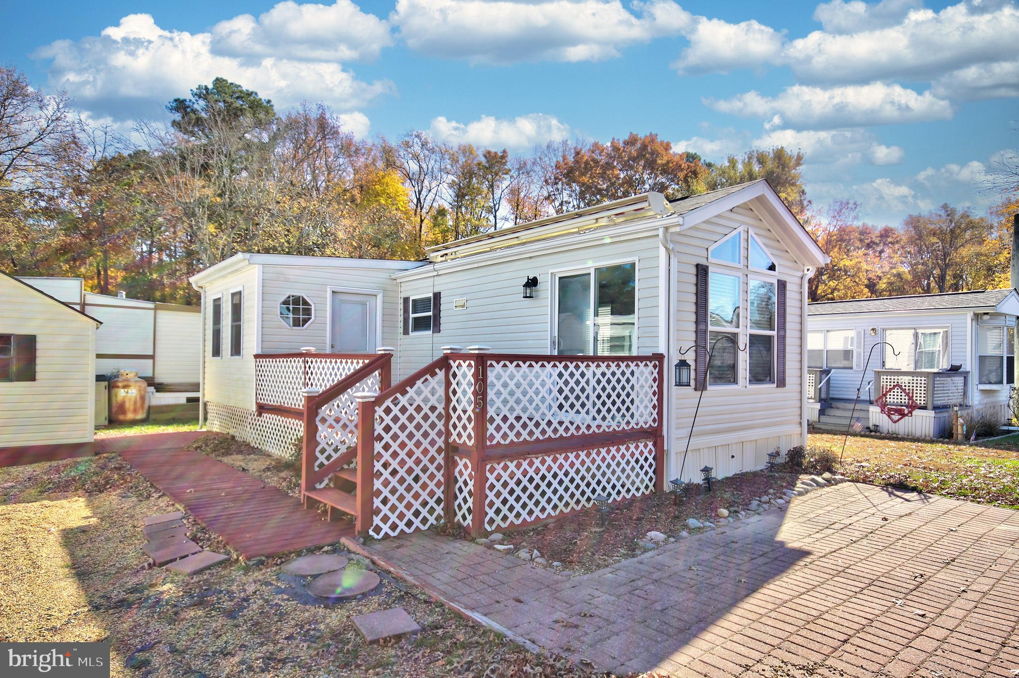 a view of a house with a wooden deck and a yard