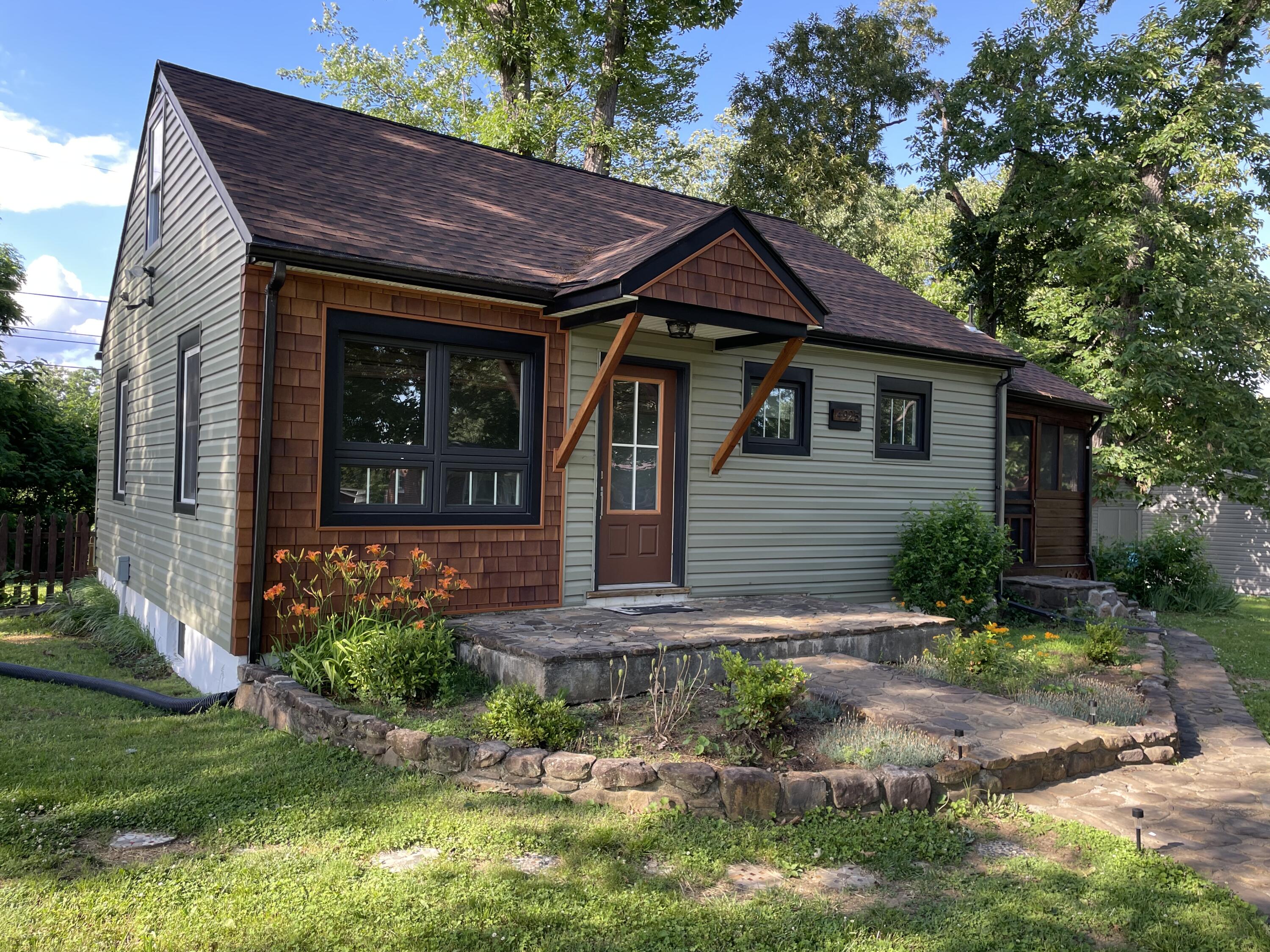 a front view of a house with garden