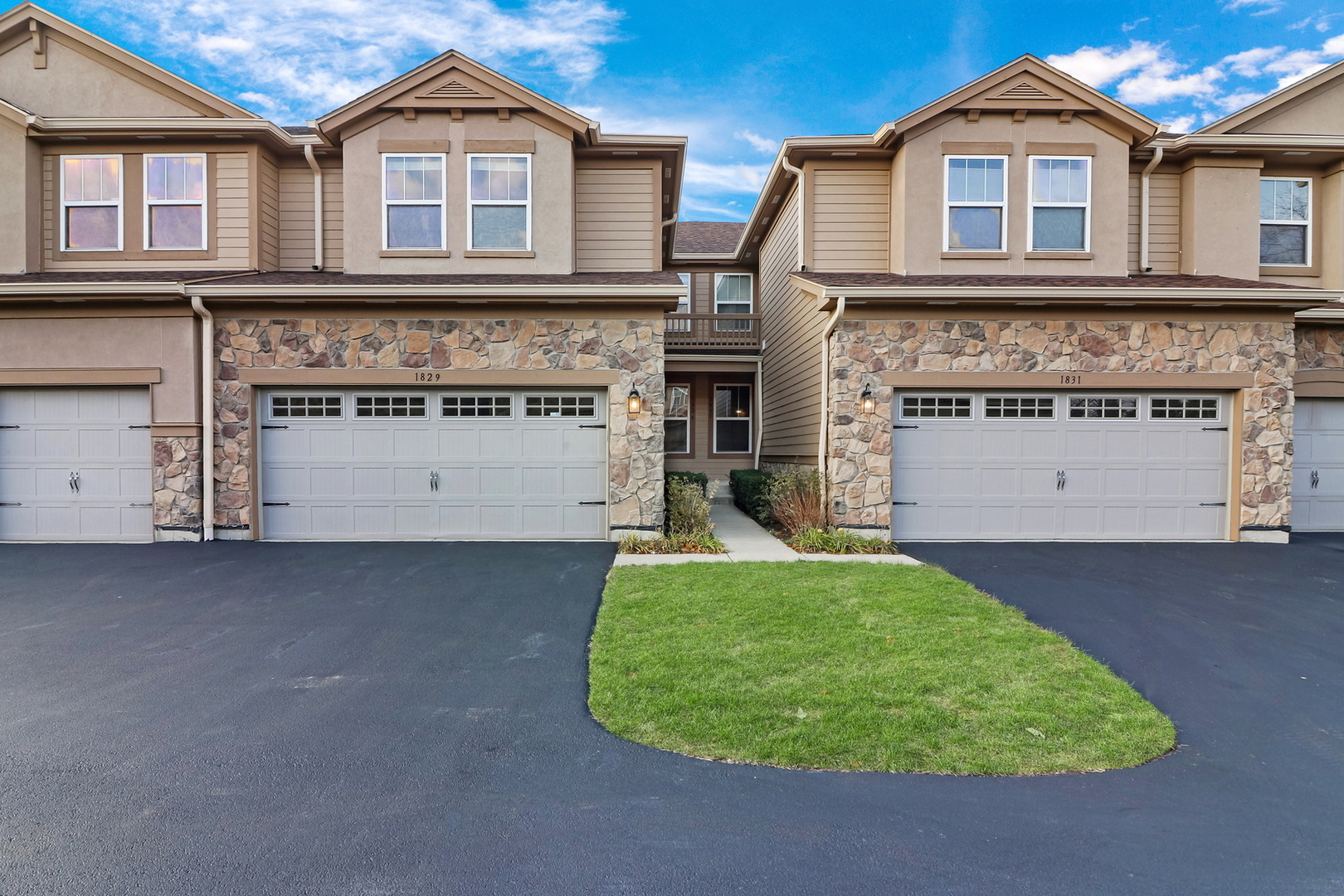 a view of a house with a yard and garage