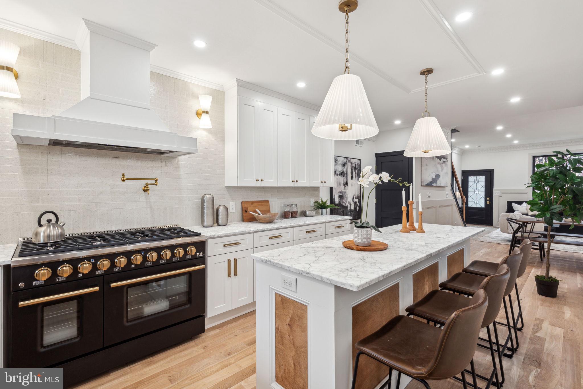 a kitchen with a stove a table and chairs