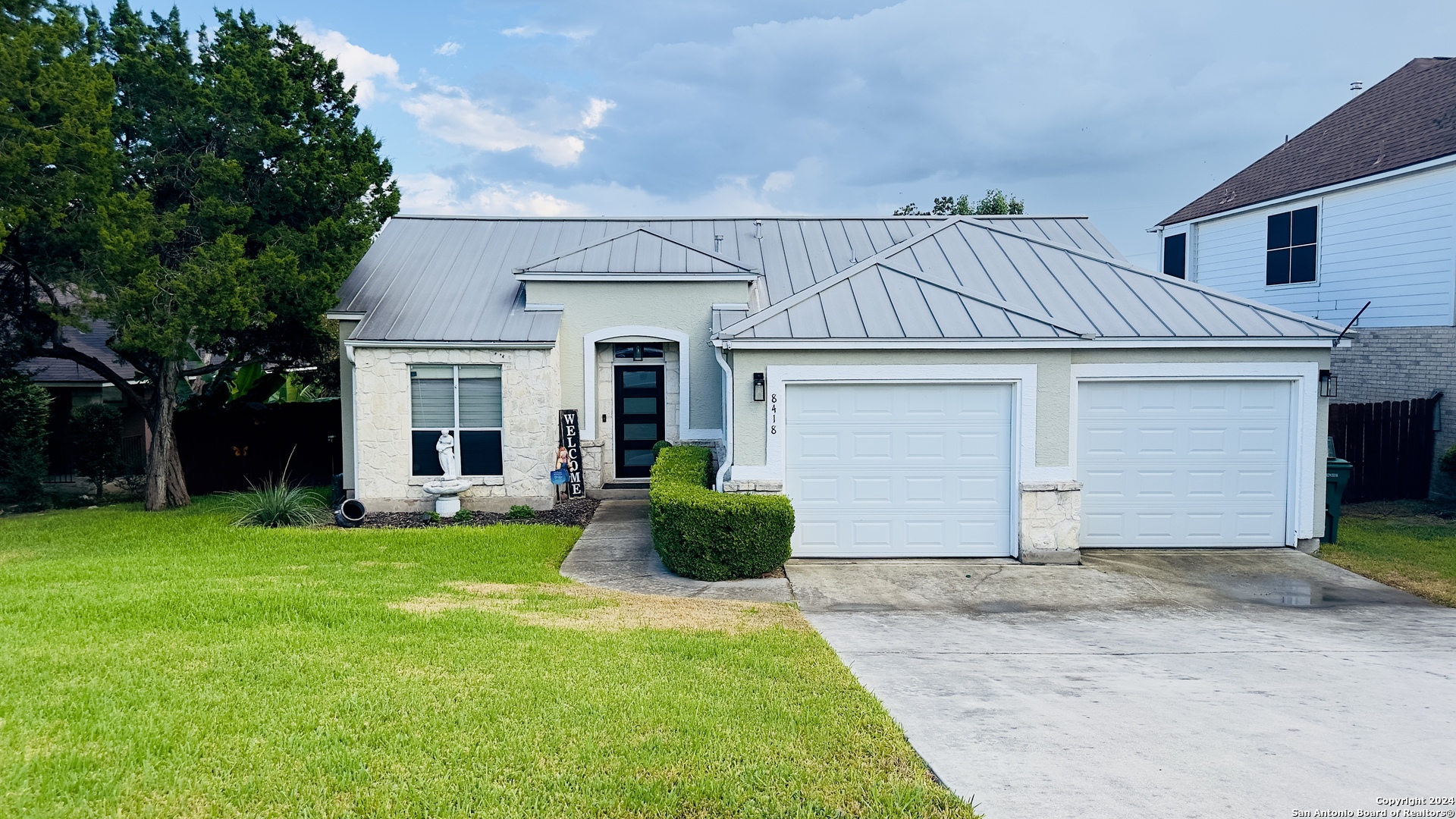 a front view of a house with a yard and garage