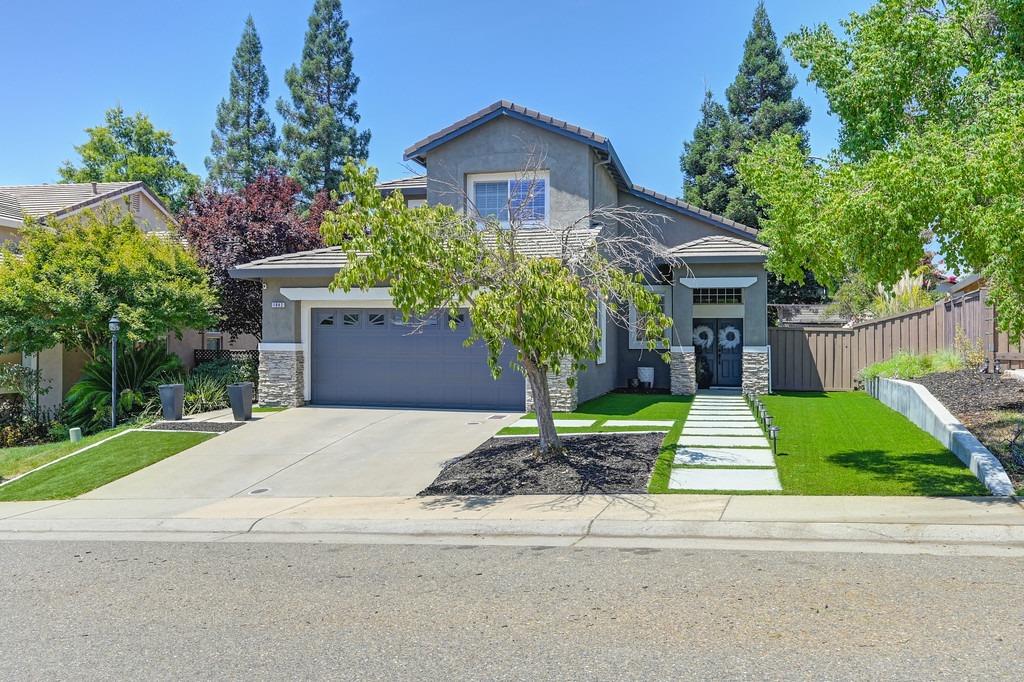 a front view of a house with a yard and garage