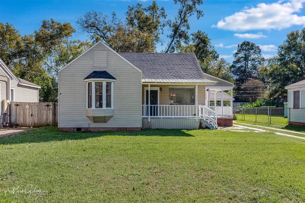 a view of a house with a yard and sitting area