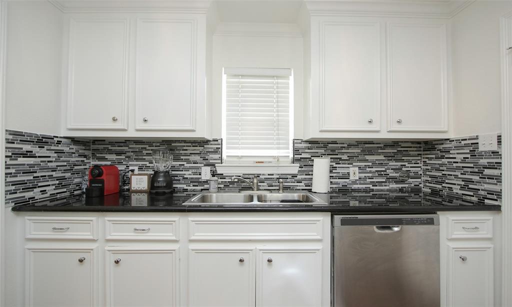 a kitchen with stainless steel appliances white cabinets and a sink