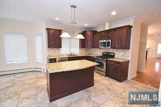 a kitchen with a stove sink and a refrigerator