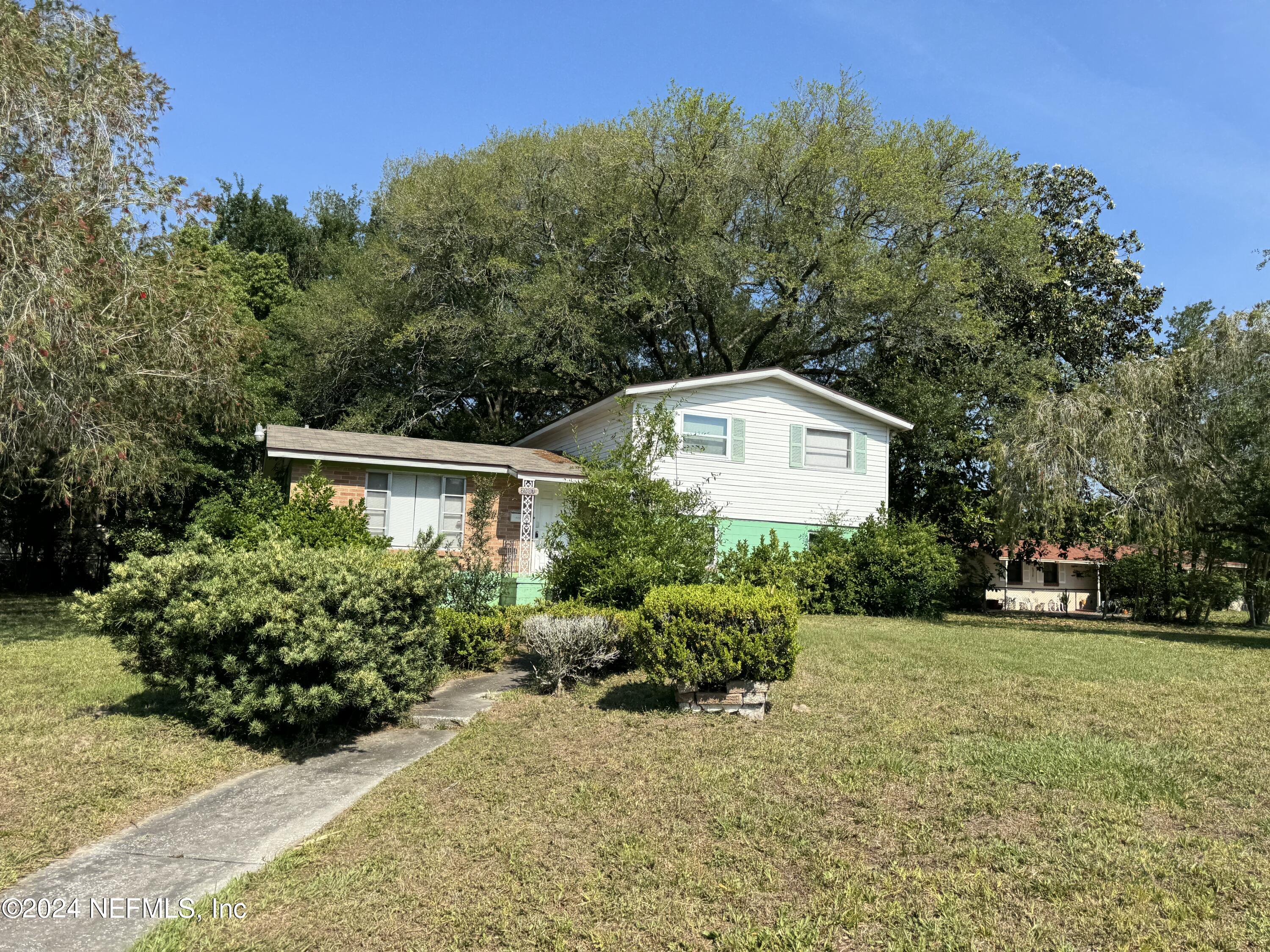 a front view of a house with a yard and outdoor space