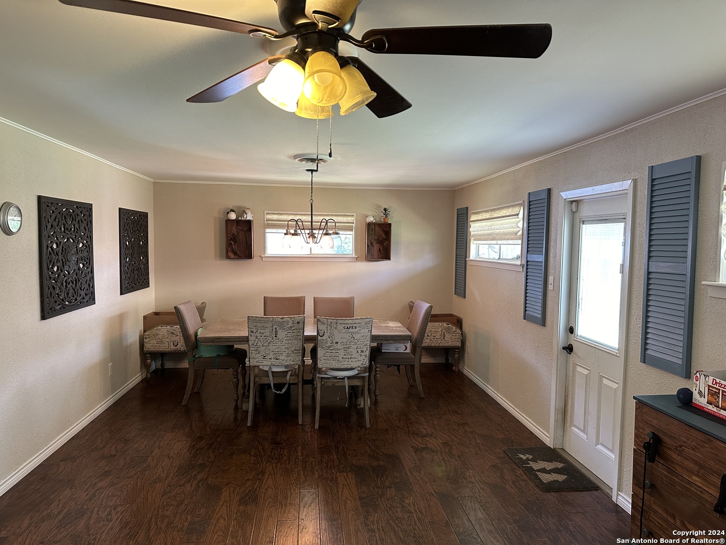 a view of a livingroom with furniture fan and wooden floor