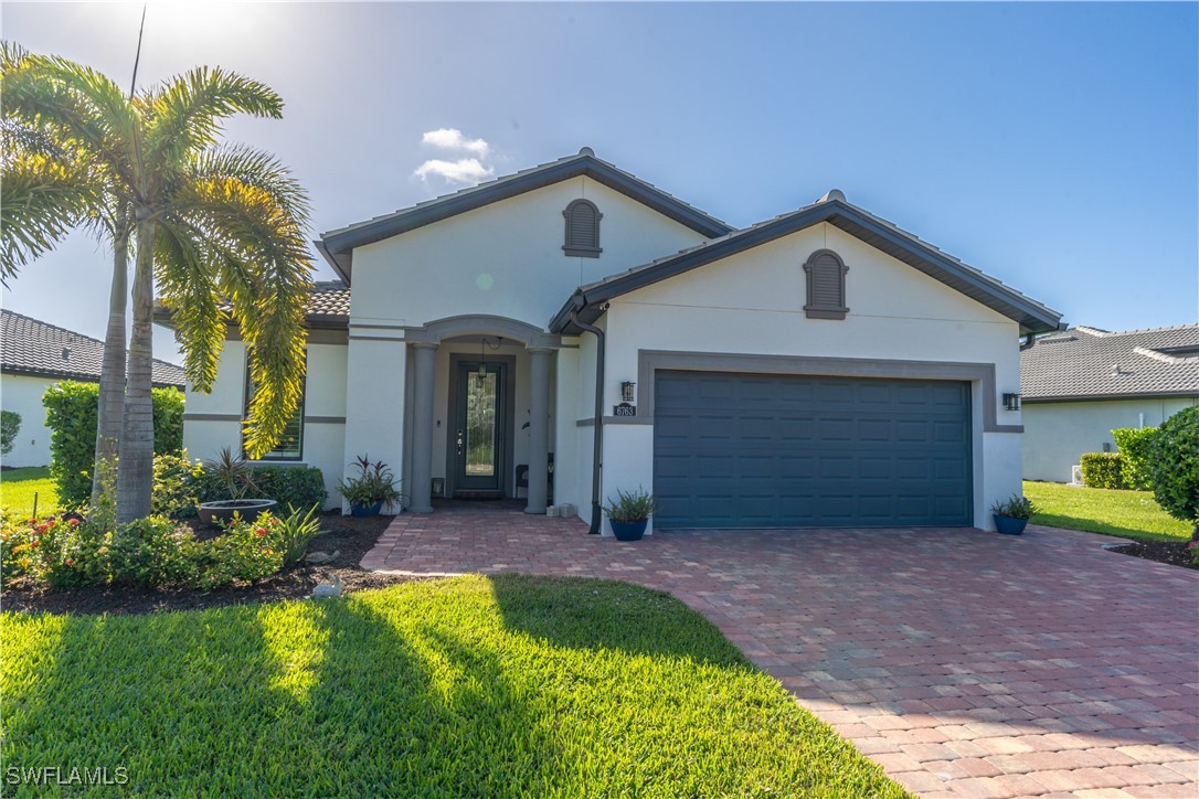 a front view of a house with a yard and garage