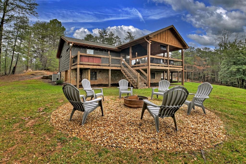 a front view of a house with garden and chairs