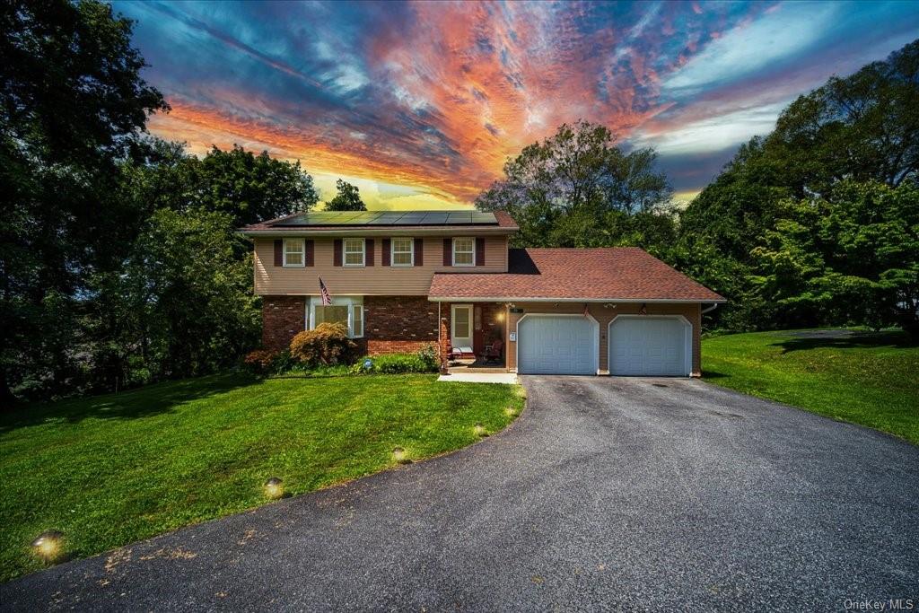 a view of a house with a yard