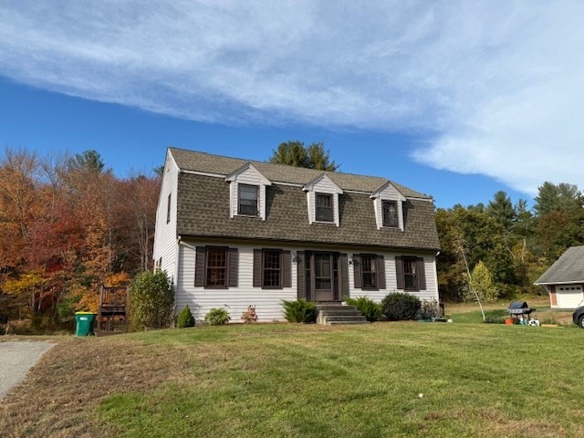 a front view of a house with a garden