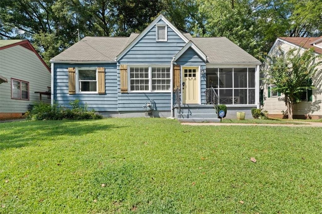 a front view of a house with a yard and outdoor seating