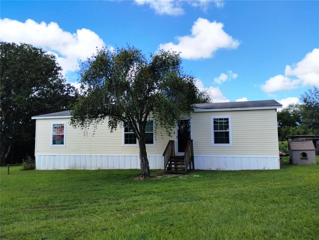 a view of house with backyard