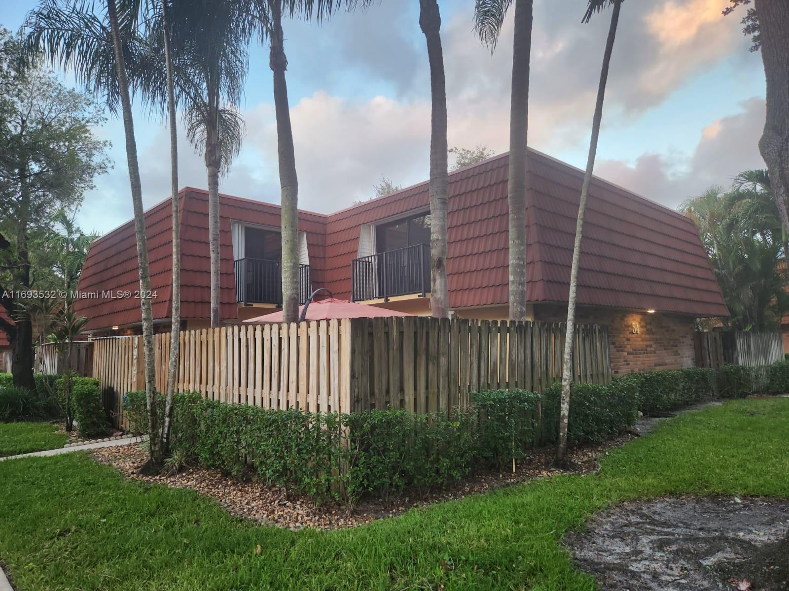 a view of a house with a small yard and plants