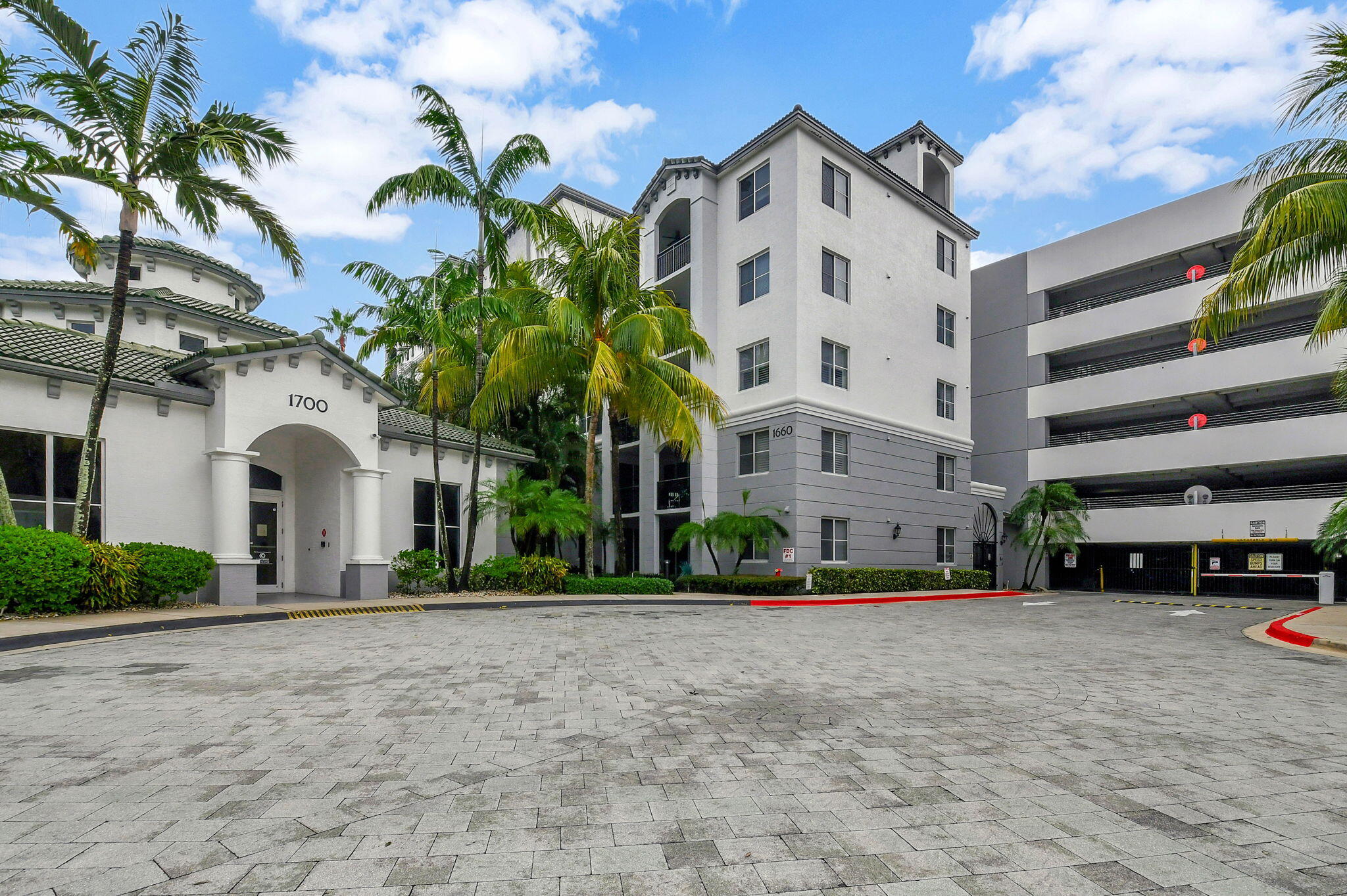 a front view of building with cars parked