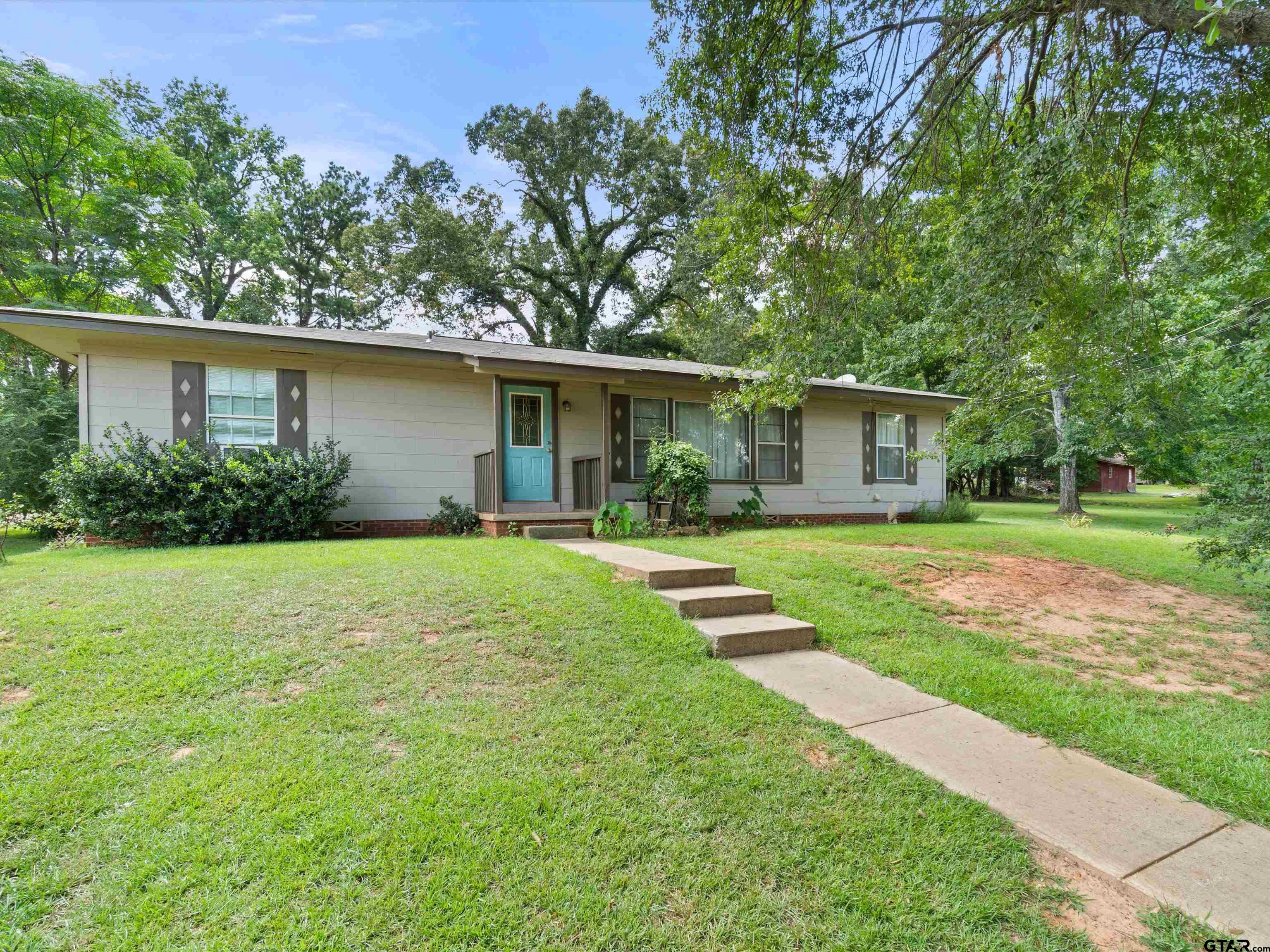 a front view of house with yard and green space