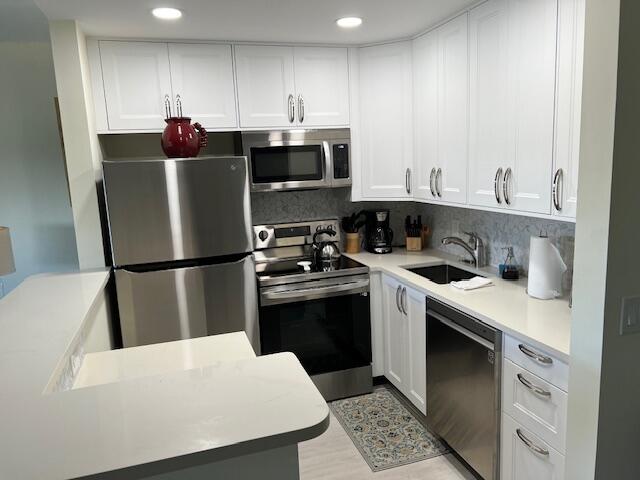 a kitchen with a stove a refrigerator and a sink