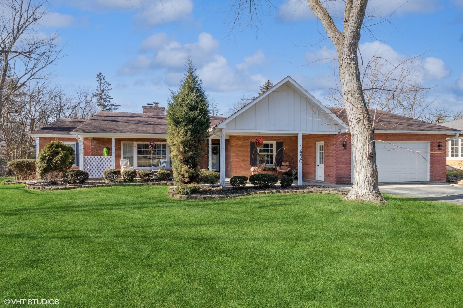 a view of a house with a yard and sitting area