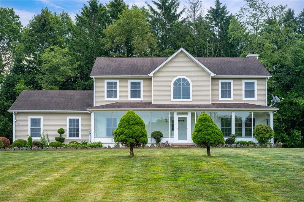 Colonial-style house with a front lawn