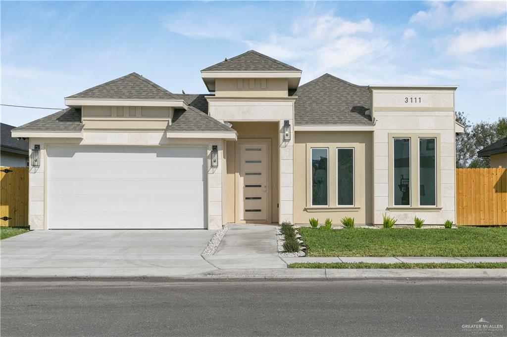 a front view of a house with a yard and garage