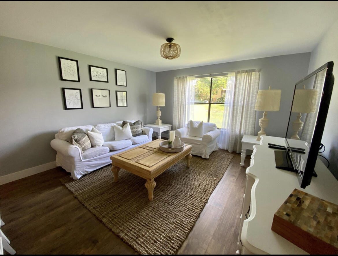 a living room with furniture rug and window