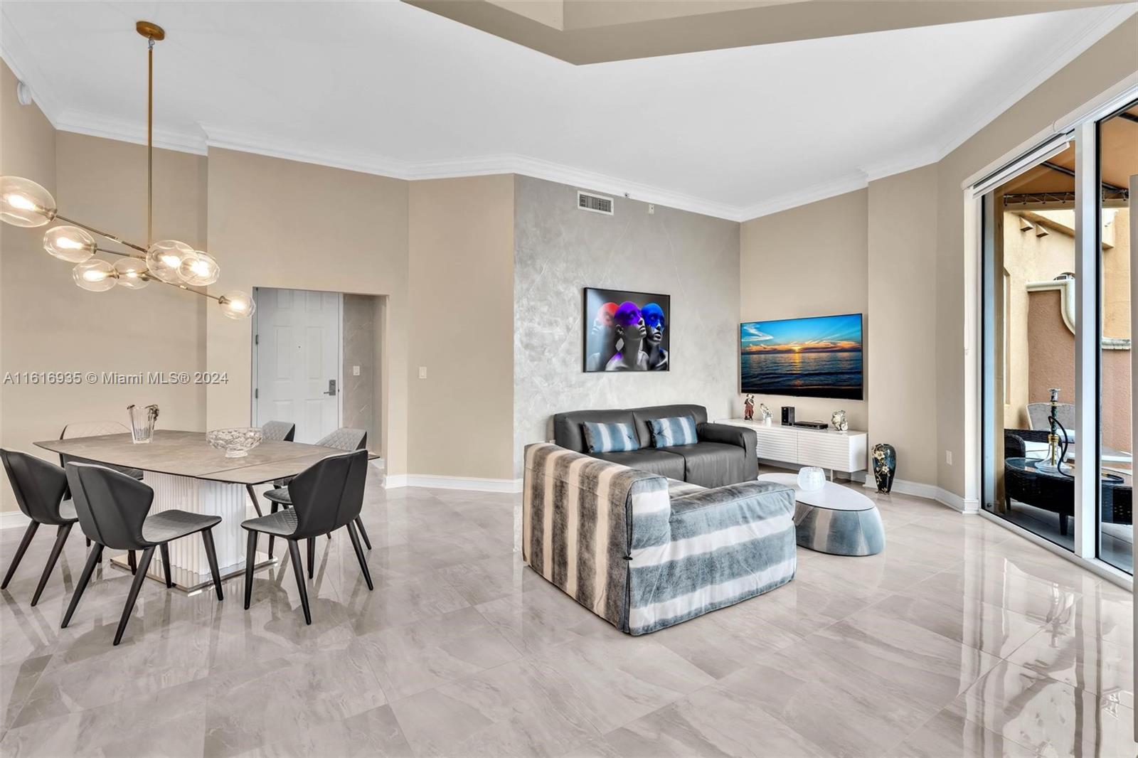 a living room with furniture a large window and a flat screen tv