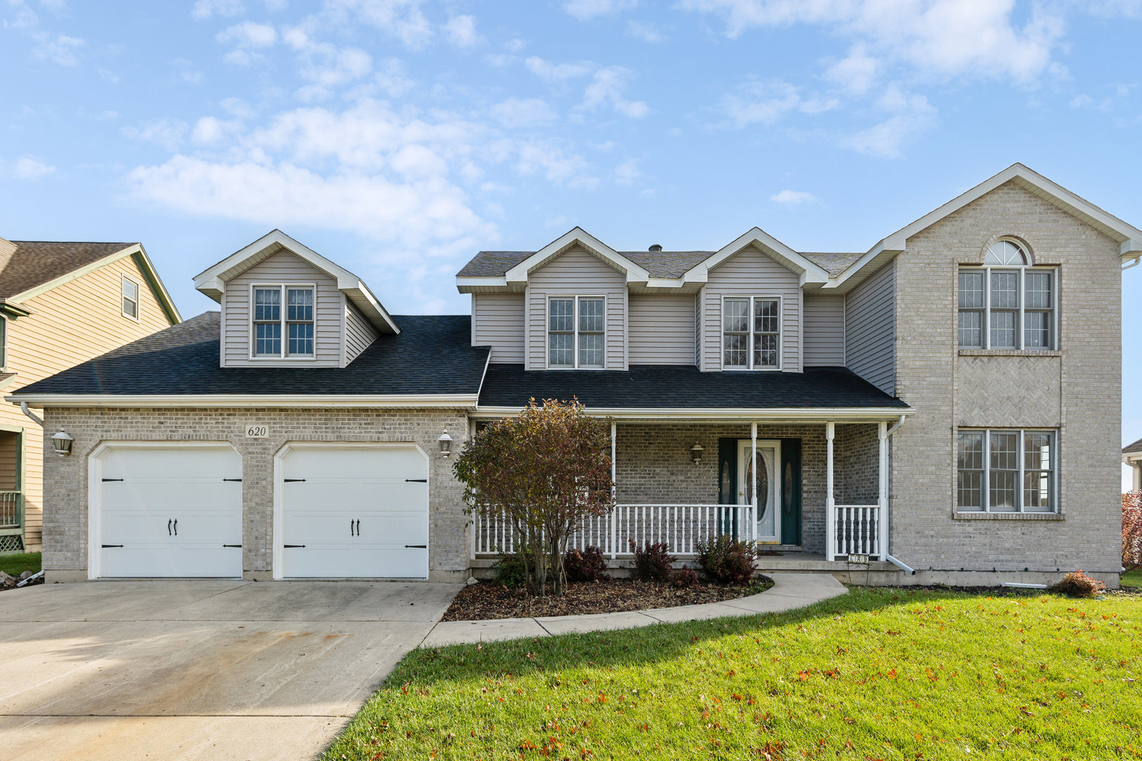 front view of a house with a yard