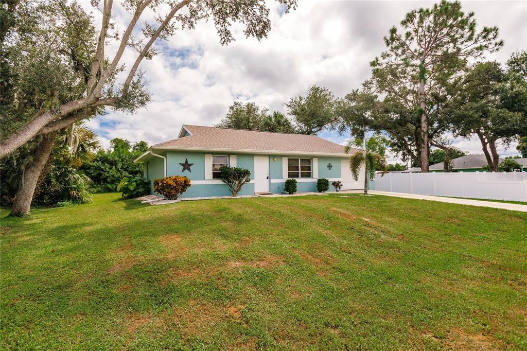 a front view of house with yard and green space