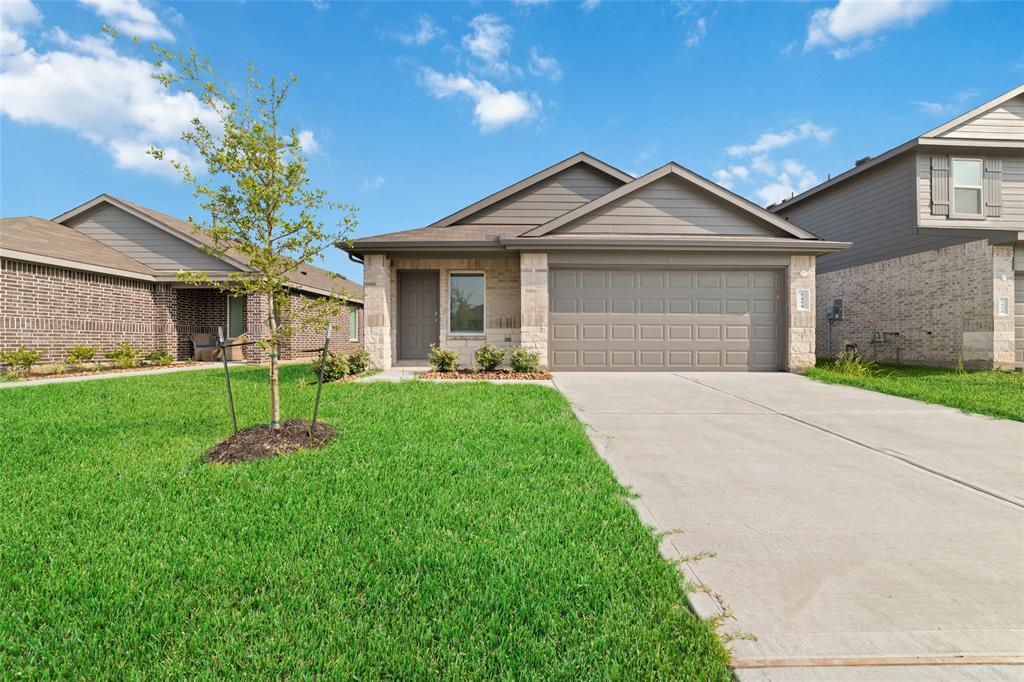 a front view of a house with a yard and garage