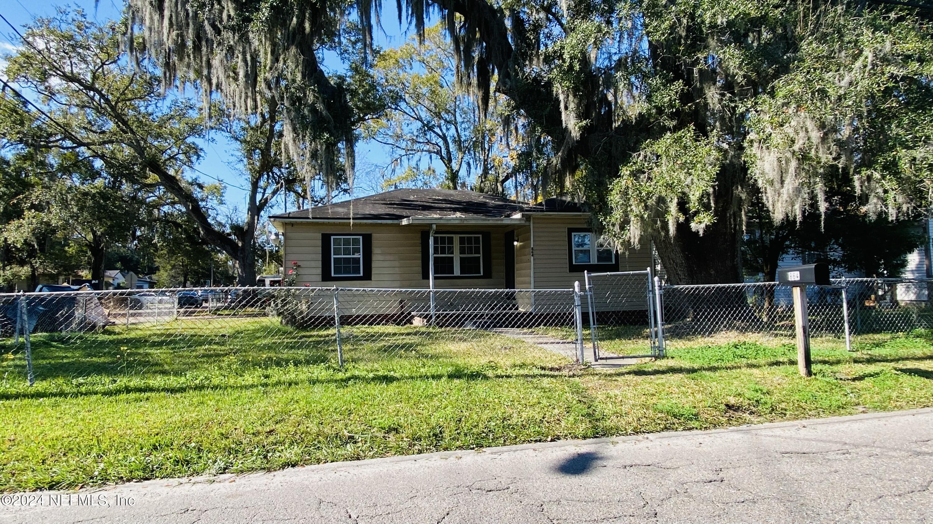 a view of a house with backyard and sitting area