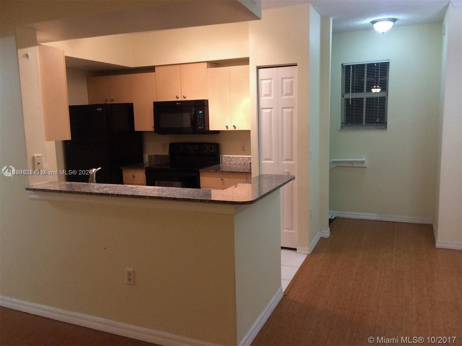 a kitchen with a sink and a refrigerator