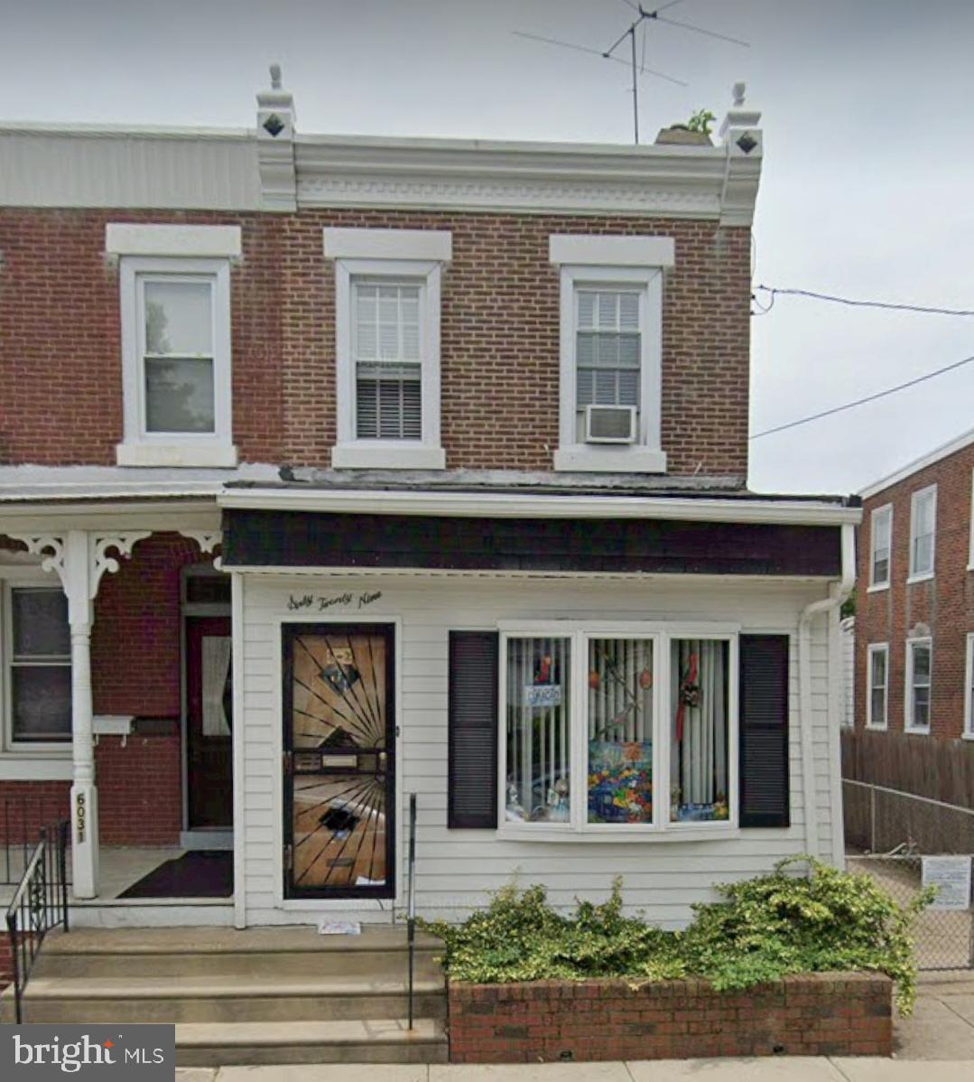 front view of a brick house with a small yard