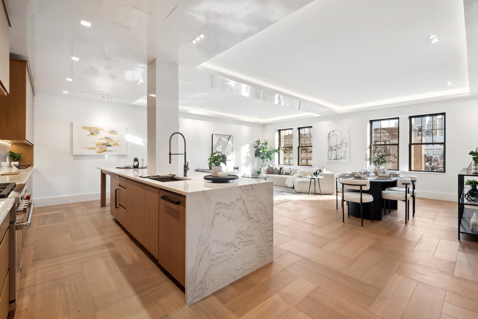 a large kitchen with kitchen island a sink a counter top space and living room view