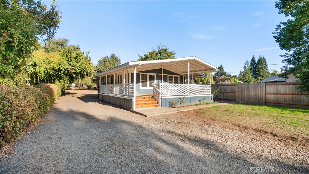 a view of a house with a yard and sitting area