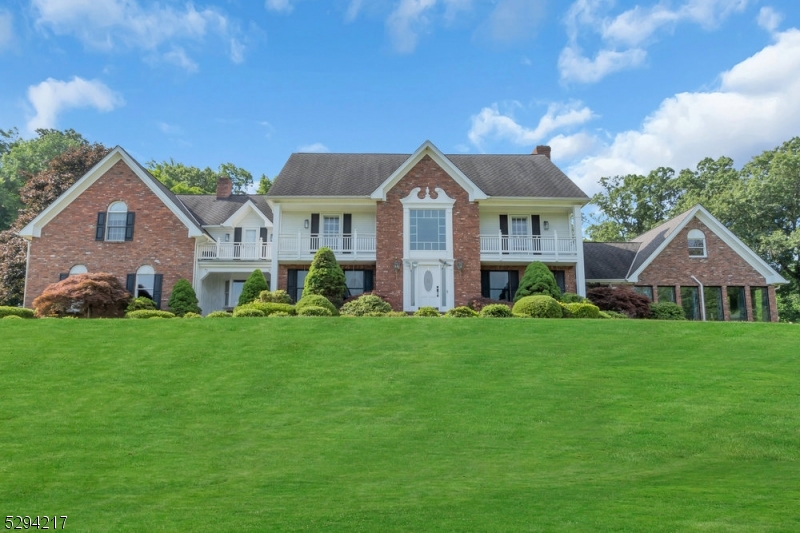 a front view of a house with a yard and trees