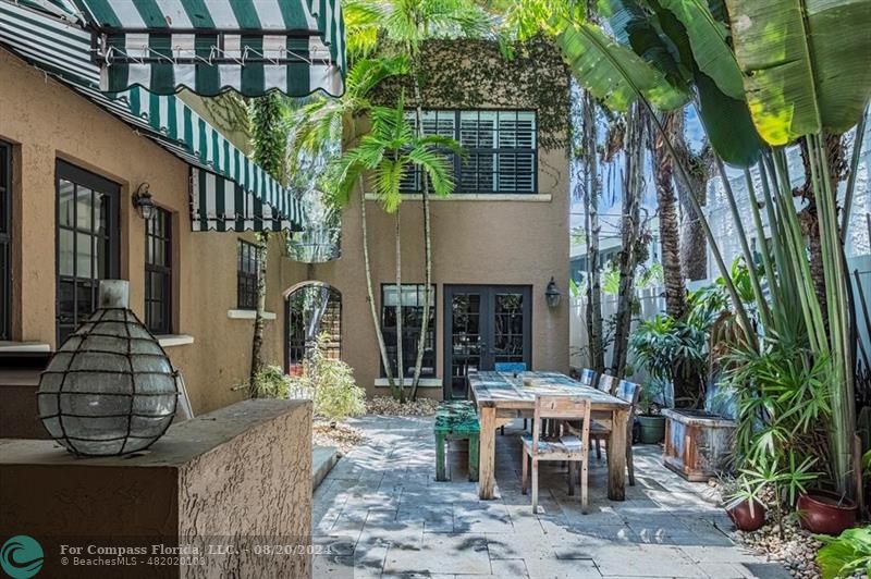 a backyard of a house with outdoor seating