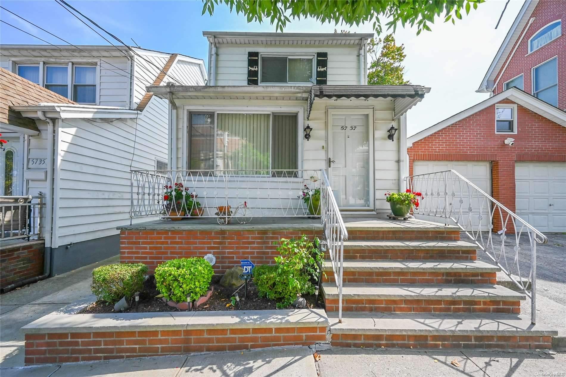 a front view of a house with potted plants