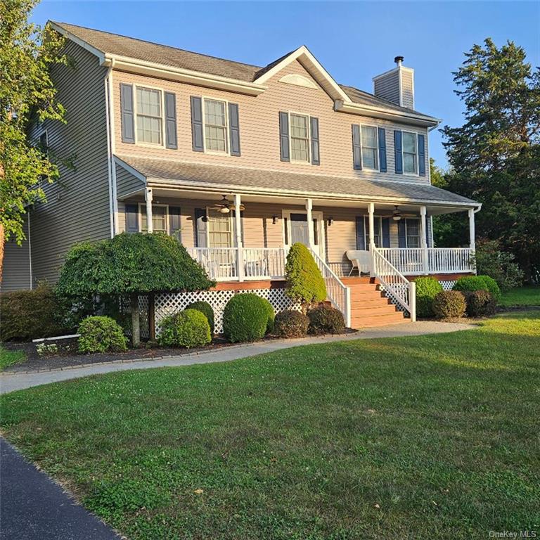 a front view of a house with a yard and trees