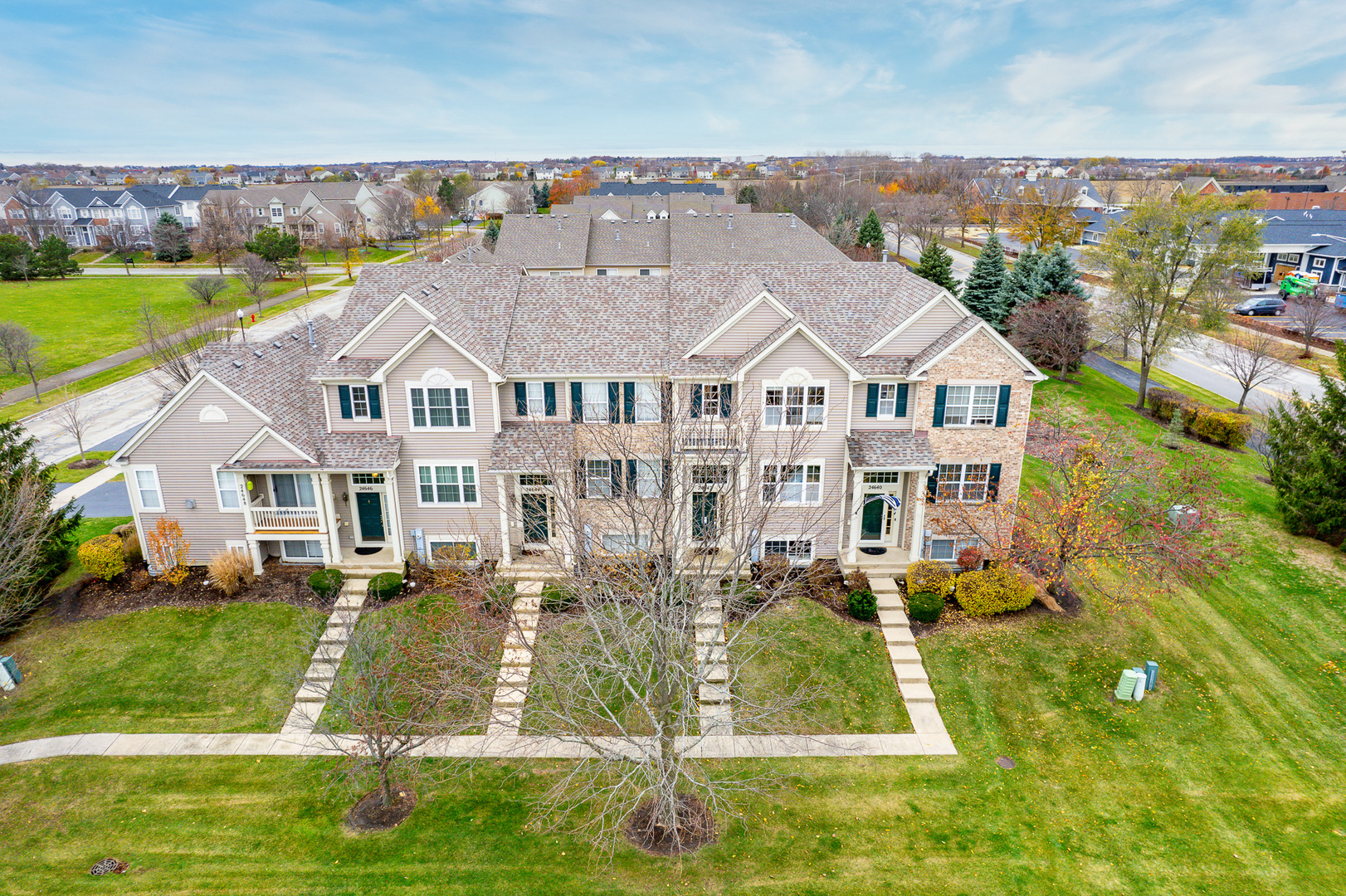 an aerial view of residential houses with outdoor space and swimming pool